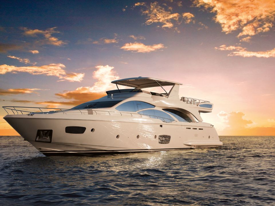 Flybridge motor yacht at sea in warm sunset light